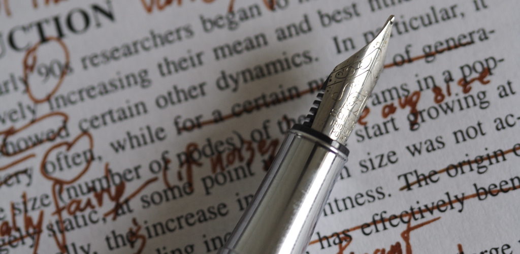 red ink edit marks on a page of text